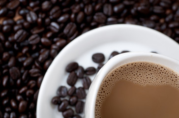 coffee beans with white coffee cup .