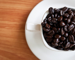 coffee beans with white coffee cup .