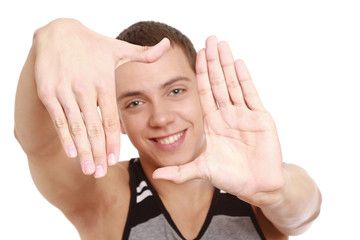 Portrait of a young man framing his face with hands