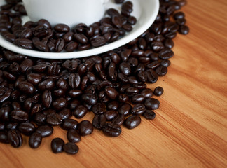 coffee beans with white coffee cup .