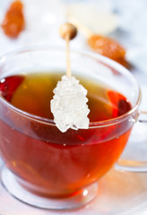 Cup of tea with sugar stick