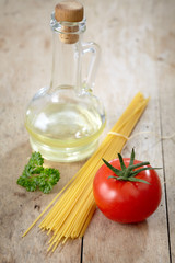 tomato and spaghetti on old wooden table