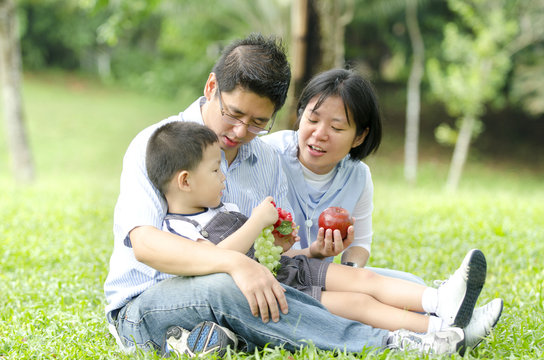 asian family having a picnic during outdoor ,focus on baby