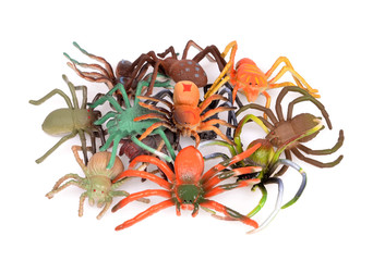 Colorful Plastic Toy Spiders on White Background