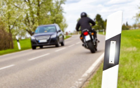 Fototapeta Motorbike and car - focus on foreground