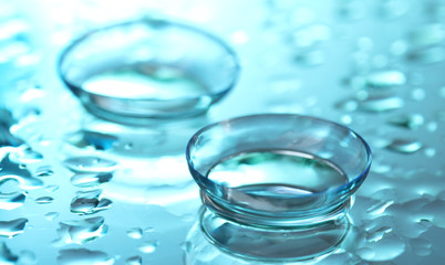 contact lens with drops on blue background