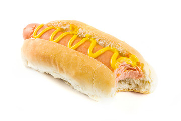Hot dog with missing bite and mustard over white