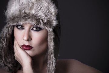 Woman frustrated with fur hat, winter concept