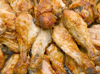 Pile of cooked chicken drumsticks