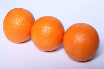 three fresh Orange fruit isolated on white