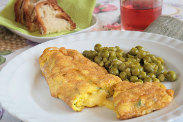 Cheese omelette with green peas, bread and wine