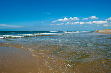 Trawler fishing at sea under a blue sky