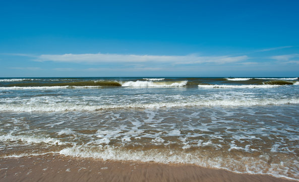 Waves of the North Sea under a blue sky
