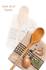 Kitchen towel with wooden spoon, herbs and spices (garlic, peppe