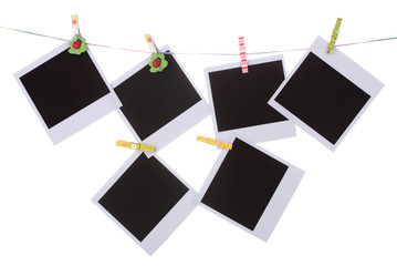 Photo paper hanging on the clothesline isolated on white