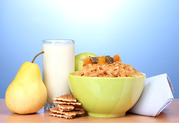tasty cornflakes in green bowl and glass of milk