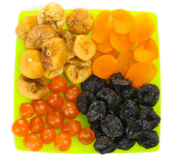 delicious dried fruits on plate isolated on white