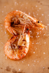 grilled shrimps prawns  with salt flakes on wood