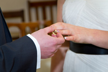 Obraz na płótnie Canvas Wedding ceremony with ring going on bride finger