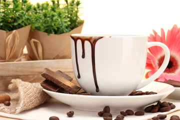 dirty cup of coffee and gerbera  beans, cinnamon sticks
