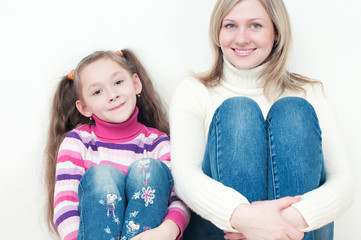 Studio portrait of happy young mother and her little daughter