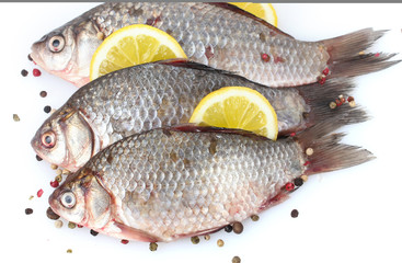 Fresh fishes with lemon and spice isolated on white