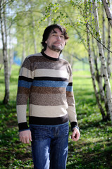 Middle-aged man in a birch grove