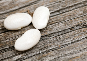 Fototapeta na wymiar white beans on wooden surface