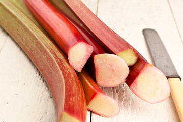 Rhubarb on a wooden table with a knife