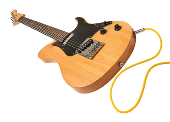yellow electric guitar with a cable plugged