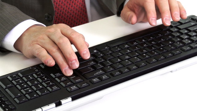 Hands of businessman typing on computer.
