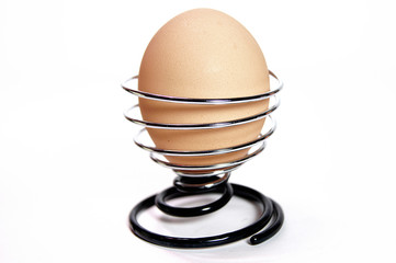 Egg in interesting stand isolated on white background