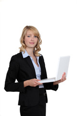 Businesswoman standing with her laptop.