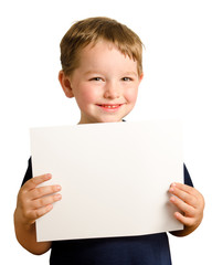 Happy preschooler boy holds up blank sign with room for copy