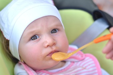 Adult feeding baby