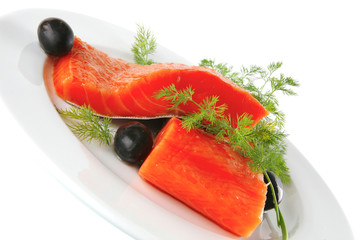 pink salmon on white plate with olives