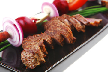 main course : meat served on black plate