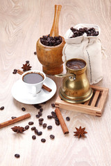 black turkish coffee served with accesories on wooden table