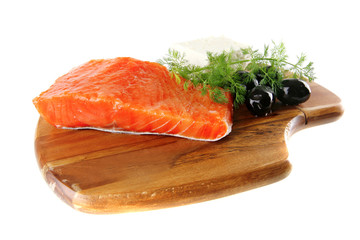 smoked salmon on wooden plate with white cheese
