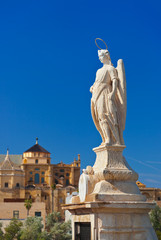 Fototapeta na wymiar Archangel Raphael statue on bridge at Cordoba Spain