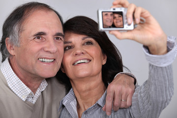 Middle aged couple taking a picture of themselves