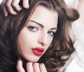 Fototapeta premium Closeup beautiful brunette woman face with sexy red lips