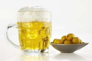 fresh beer and olives over white background