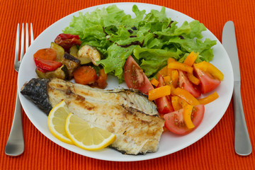 fried fish with vegetables and salad