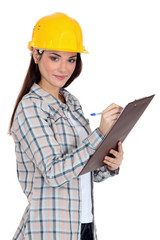 Female construction worker writing on her clipboard.