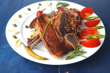 lamb meat fillet ready on china plate with tomatoes