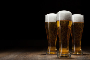 three glass beer on wooden table with copyspace