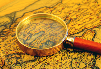 Old map and  magnifier glass