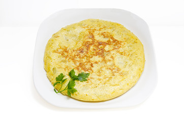 Slices of Spanish omelet or tortilla de patatas on a white plate