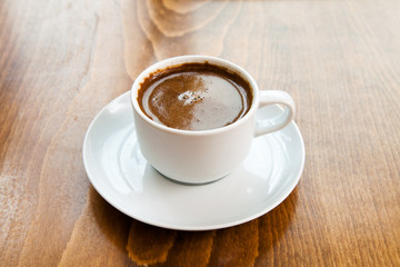 Fototapeta premium Greek turkish coffee served in a white cup